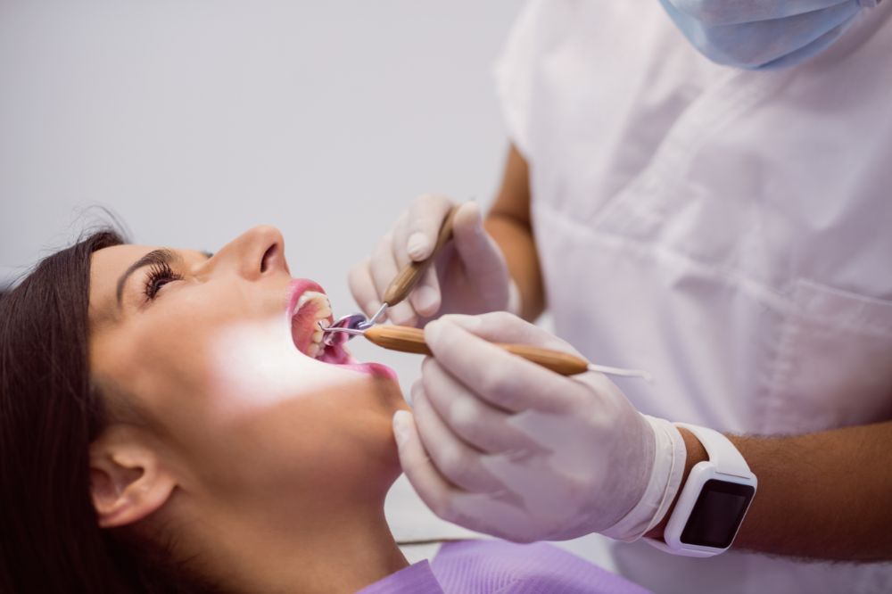 a woman is getting dental treatment