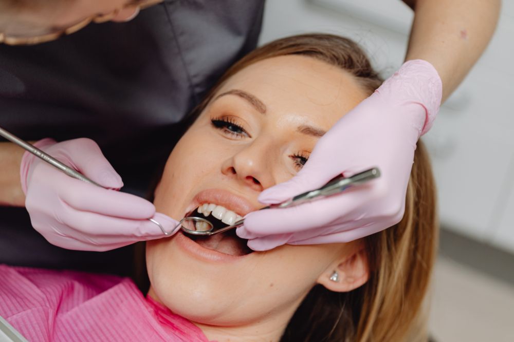a woman is getting dental treatment.